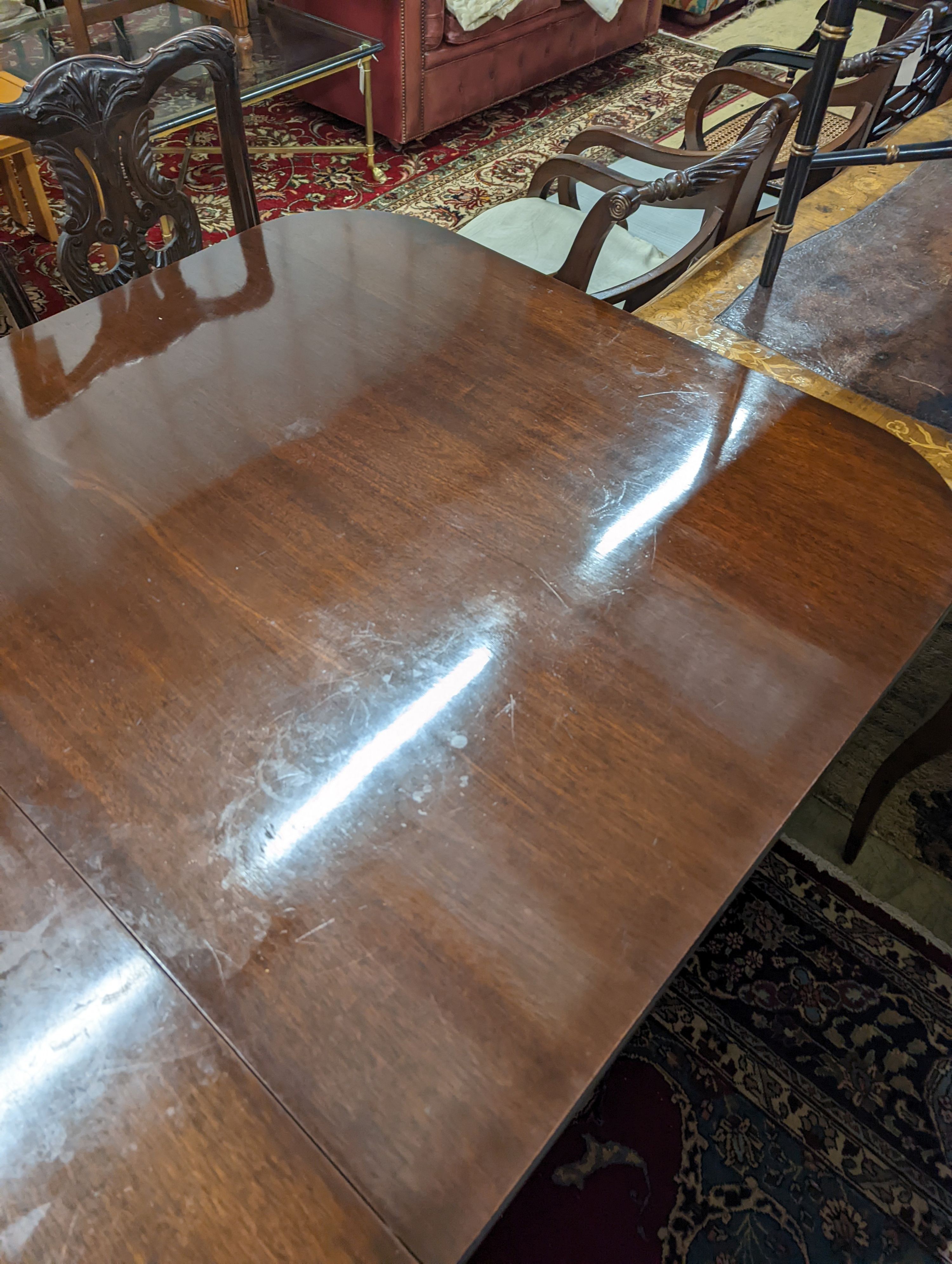 A reproduction George III style rectangular mahogany extending dining table, 241cm extended, one spare leaf, depth 104cm, height 74cm